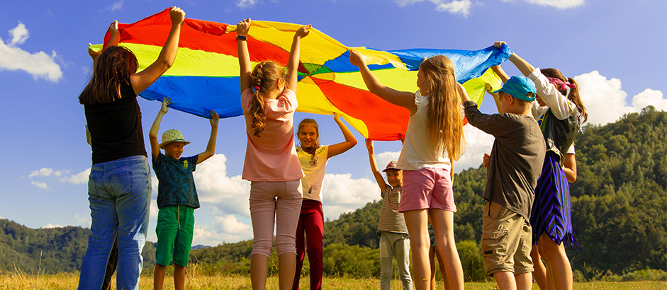 children-playing-with-parachute Children playing with a parachute at summer camp